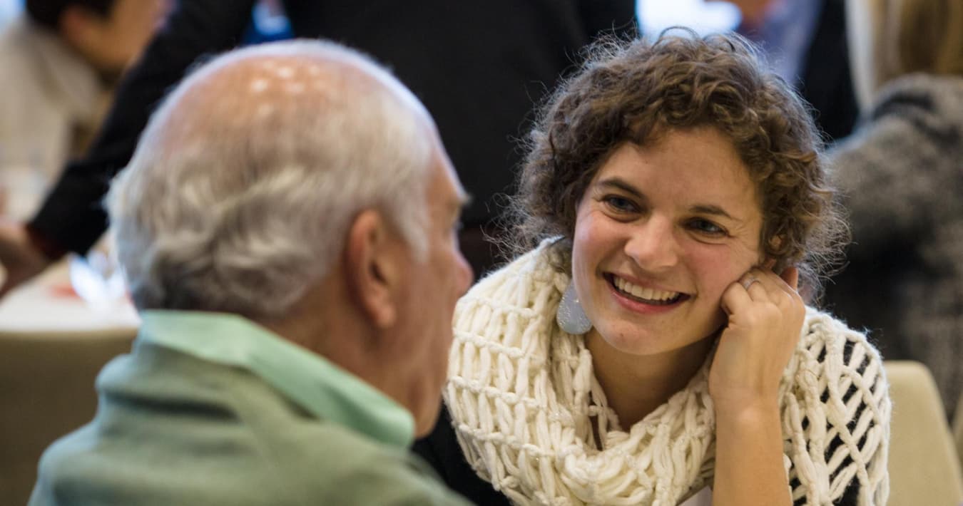 MIT researcher smiles at event participant