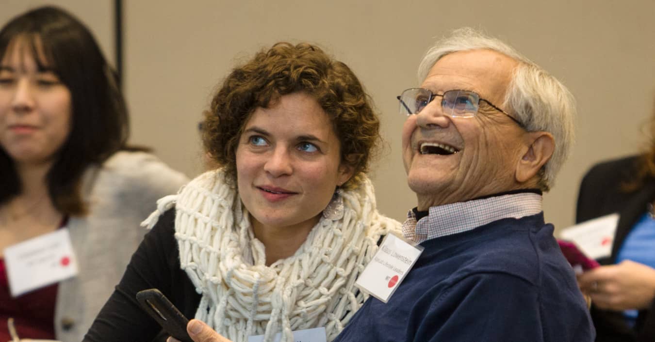 Researcher and participant enjoy presentation