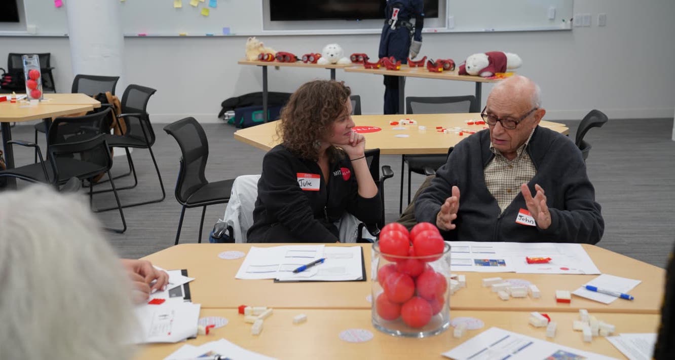 Woman talking to an older gentleman at a table