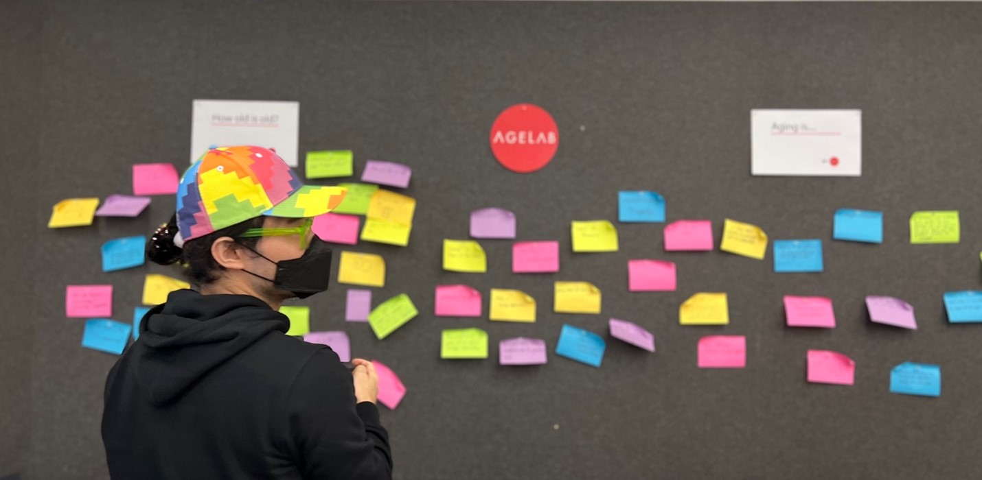 Author in front of board of post-it notes